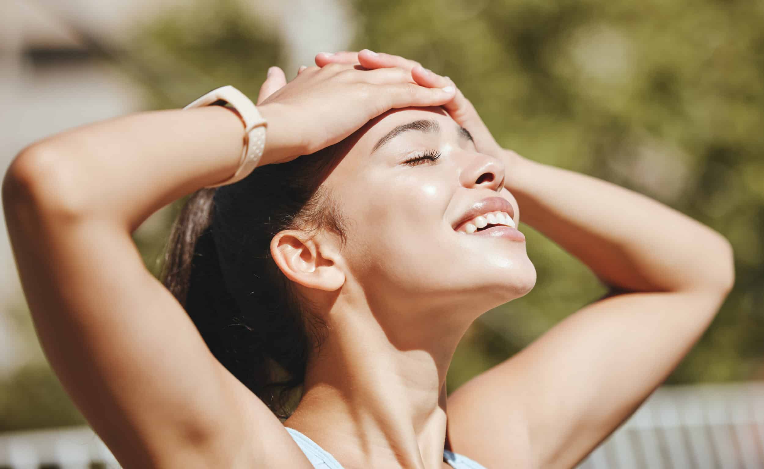 Face, relax and woman in sun happy with outdoor leisure and peaceful break for mental wellness. Stress free latino girl with relaxed, optimistic and positive smile enjoying sunshine rest.